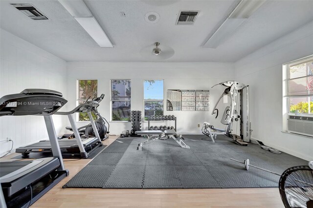 game room with hardwood / wood-style floors, pool table, and a wealth of natural light