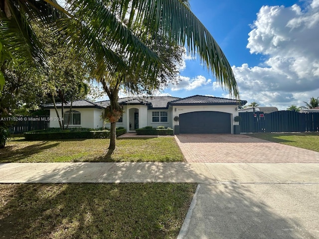 view of front of property featuring a garage and a front lawn