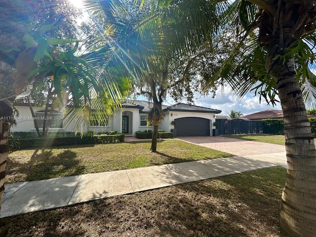 view of front of home featuring a garage and a front lawn