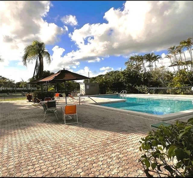 view of swimming pool with a patio area and a gazebo