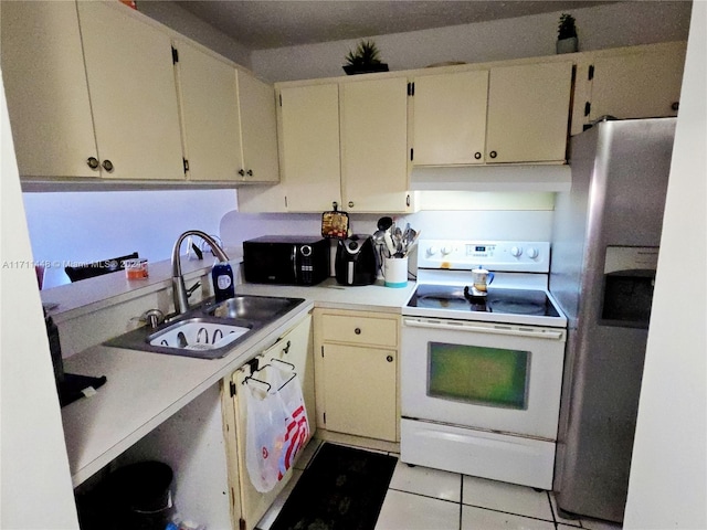 kitchen with white range with electric stovetop, sink, stainless steel refrigerator with ice dispenser, and cream cabinetry