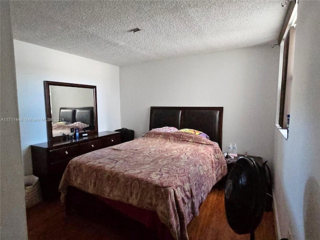 bedroom featuring wood-type flooring and a textured ceiling