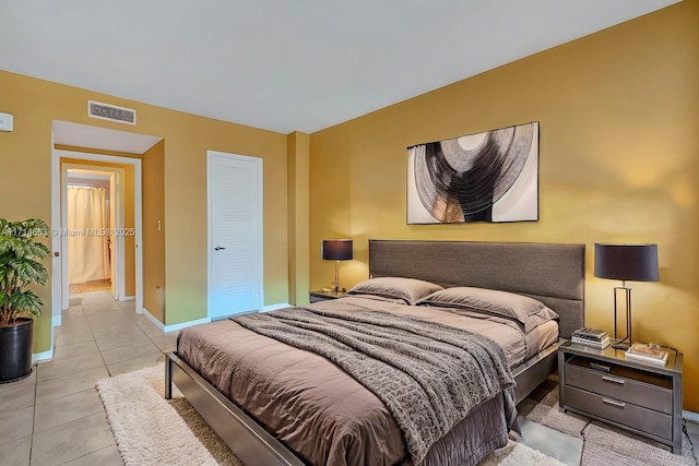 tiled bedroom featuring a closet