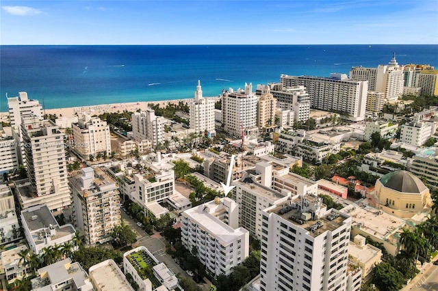 birds eye view of property with a beach view and a water view