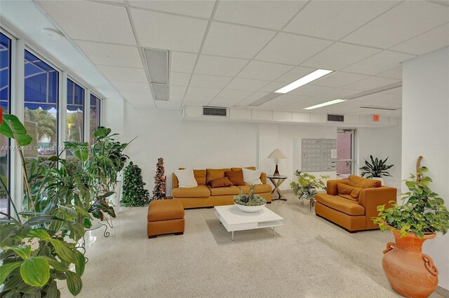 living room with a drop ceiling