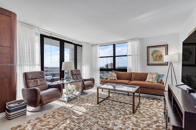 living room featuring expansive windows and light tile patterned floors