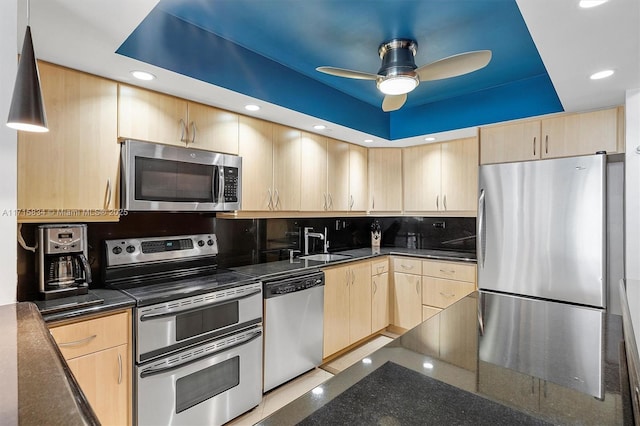 kitchen with sink, ceiling fan, tasteful backsplash, light brown cabinetry, and appliances with stainless steel finishes