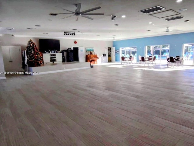 exercise room with hardwood / wood-style flooring and ceiling fan