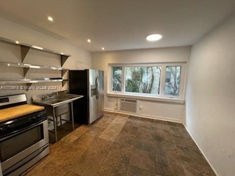 kitchen featuring stainless steel appliances and a wall unit AC