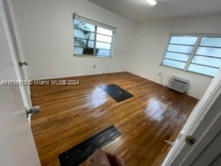 spare room featuring dark hardwood / wood-style flooring