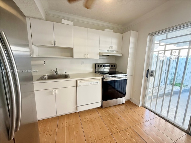 kitchen with white cabinets, appliances with stainless steel finishes, crown molding, and sink