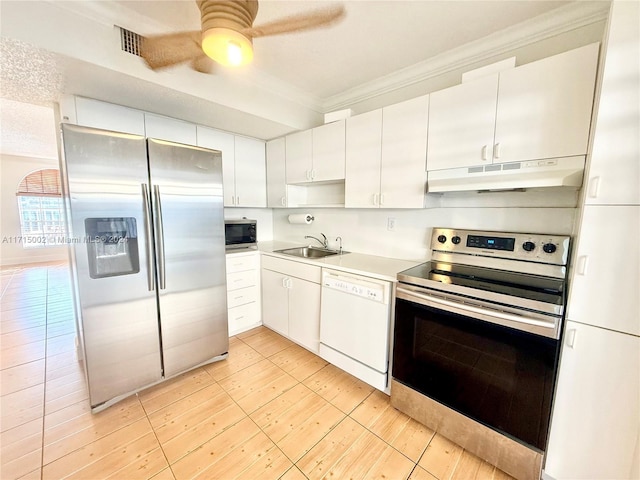 kitchen featuring white cabinets, stainless steel appliances, crown molding, and sink