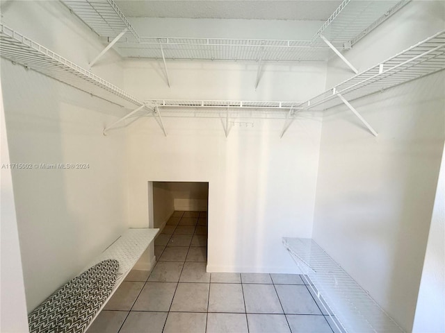 walk in closet with tile patterned floors