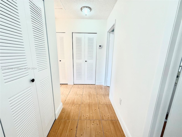 corridor featuring a textured ceiling