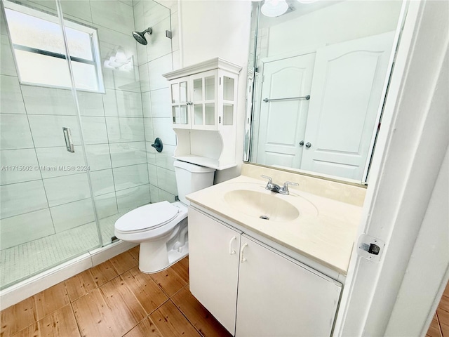 bathroom featuring vanity, an enclosed shower, and toilet