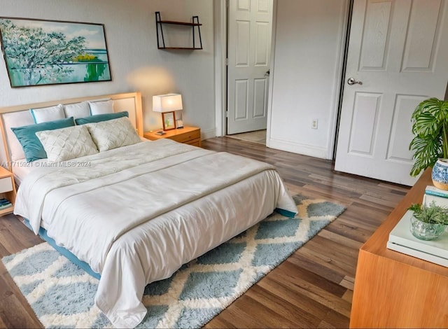 bedroom with dark hardwood / wood-style flooring