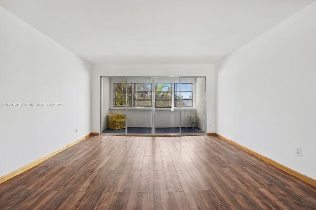 spare room featuring dark wood-type flooring