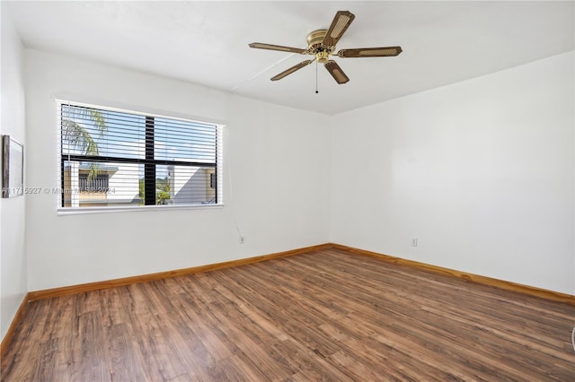 spare room with hardwood / wood-style floors and ceiling fan