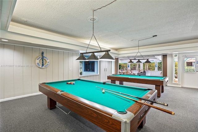 recreation room featuring a raised ceiling, a textured ceiling, dark carpet, and billiards