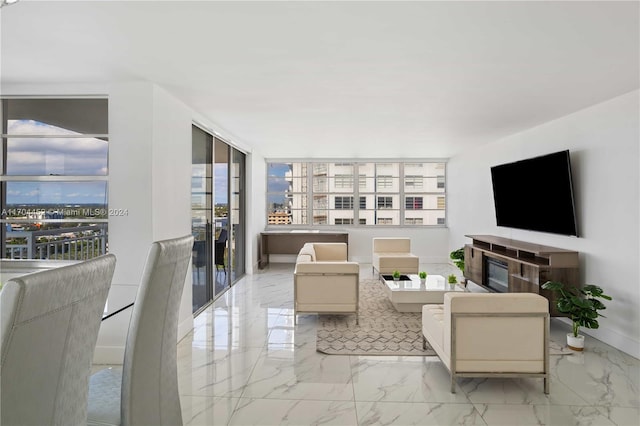 living room featuring a wealth of natural light and a wall of windows