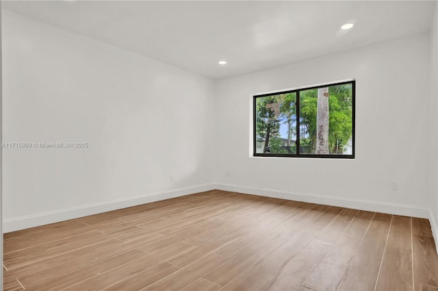 unfurnished room with light hardwood / wood-style flooring