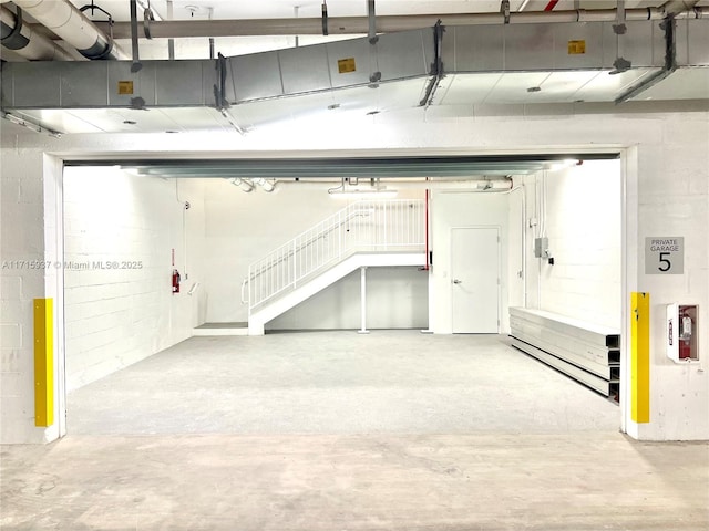 garage with concrete block wall