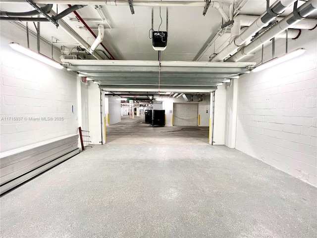garage with a garage door opener and a baseboard radiator