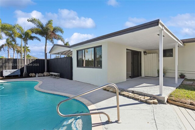 view of swimming pool featuring a lawn and a patio