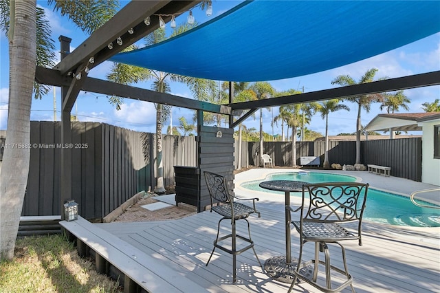 wooden deck featuring a fenced in pool