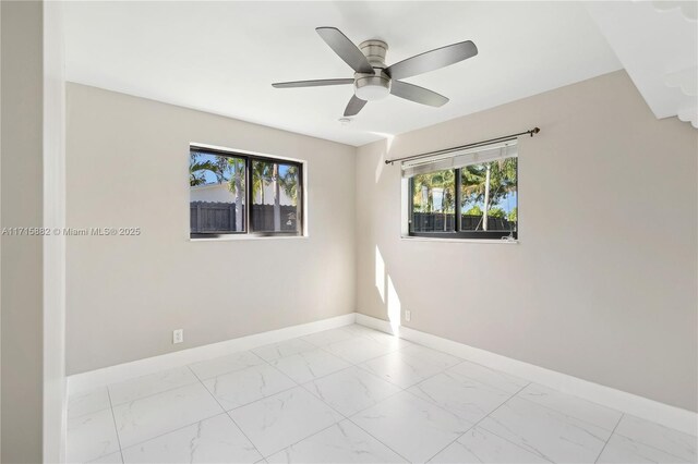 unfurnished room with plenty of natural light and ceiling fan