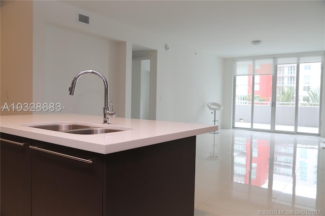 kitchen featuring sink and light tile patterned flooring