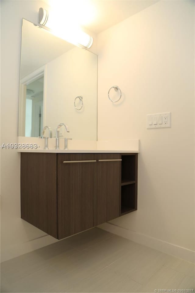 bathroom with tile patterned floors and vanity