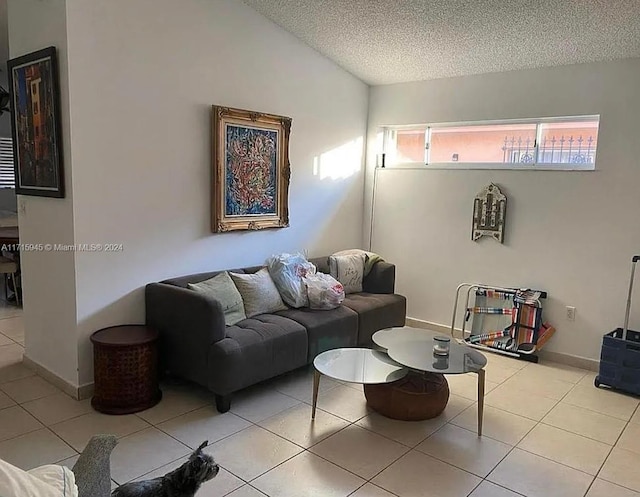 tiled living room featuring a textured ceiling and lofted ceiling