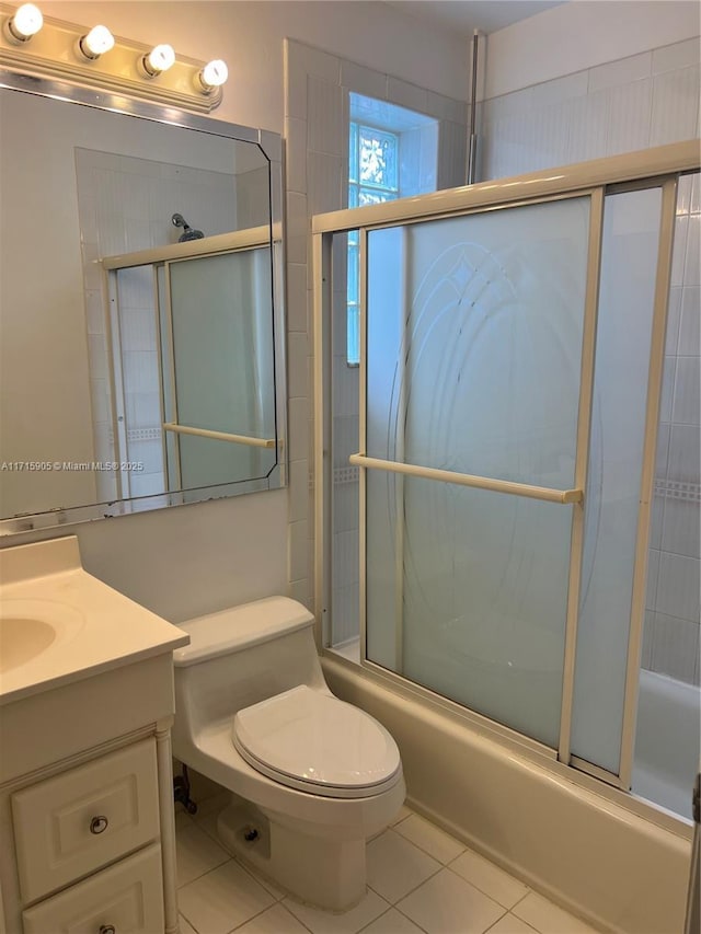 full bathroom with tile patterned flooring, vanity, toilet, and enclosed tub / shower combo