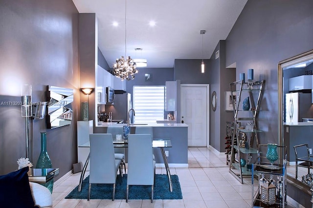 dining area with light tile patterned floors, an inviting chandelier, and baseboards