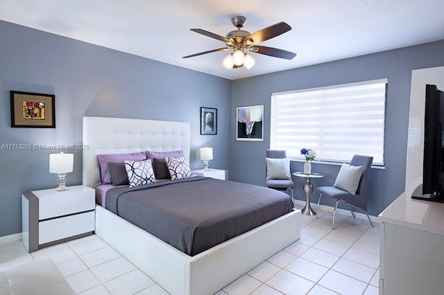 bedroom with light tile patterned floors, ceiling fan, and baseboards