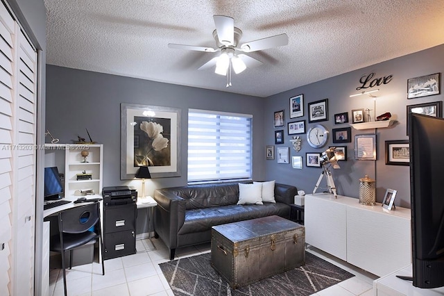 office space with light tile patterned floors, ceiling fan, and a textured ceiling