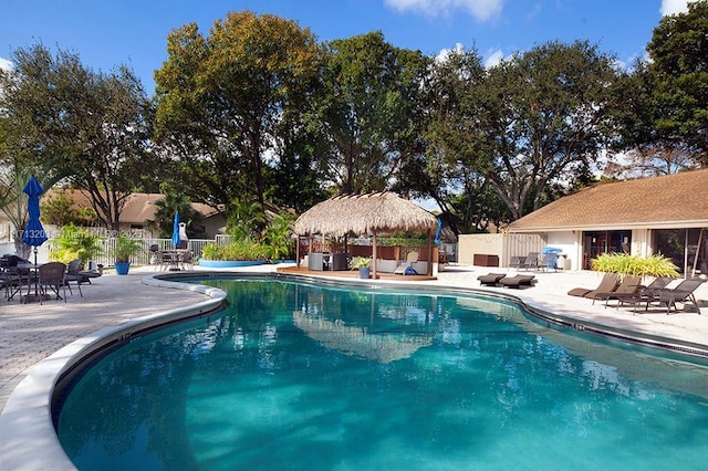 pool featuring a patio, a gazebo, and fence