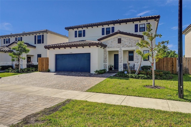 mediterranean / spanish home with a front yard and a garage