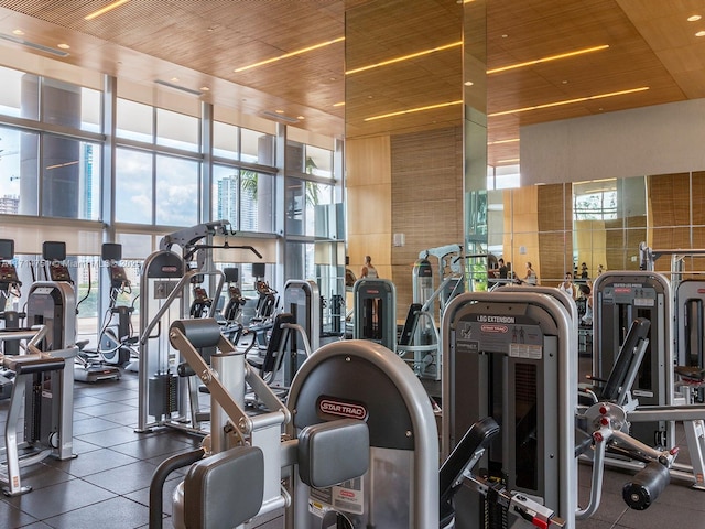 exercise room featuring a healthy amount of sunlight and wooden ceiling