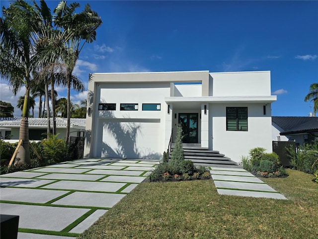 view of front of home featuring a front yard and stucco siding