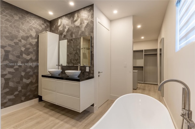 bathroom featuring vanity, shower with separate bathtub, and hardwood / wood-style floors