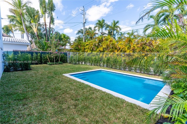 view of pool with a fenced in pool, a fenced backyard, and a yard