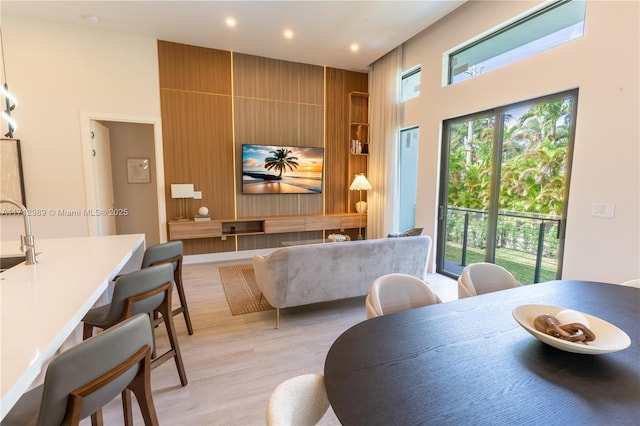 dining area with light wood-type flooring and recessed lighting