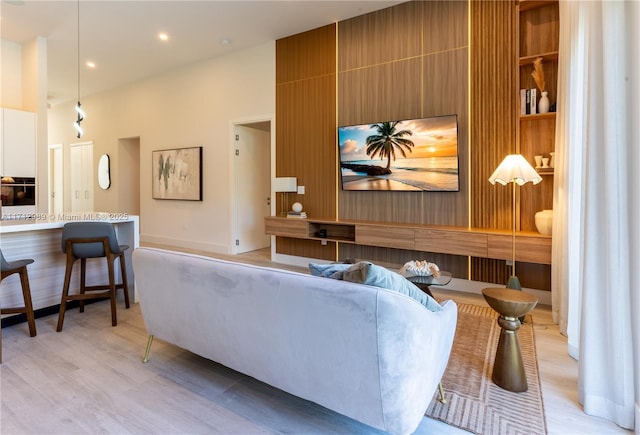 living area with recessed lighting and light wood-style floors