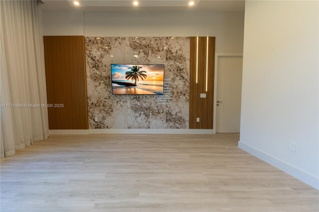 unfurnished room with light hardwood / wood-style flooring