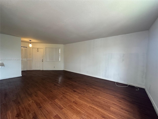 empty room featuring dark hardwood / wood-style flooring