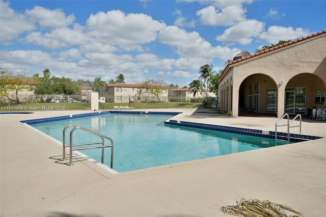 view of swimming pool with a patio area