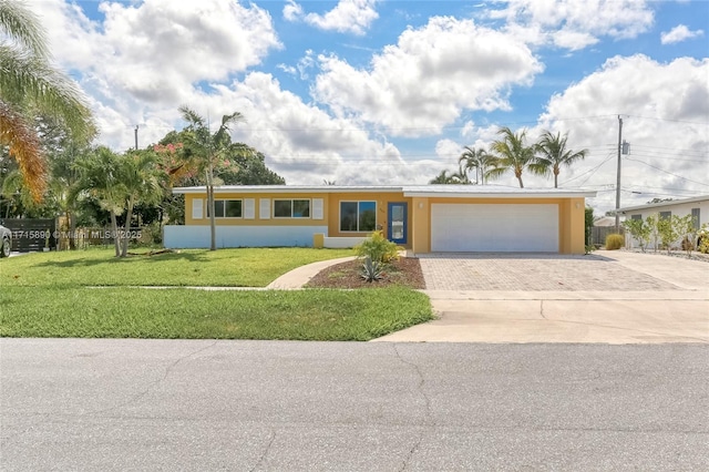 ranch-style house featuring a garage and a front yard