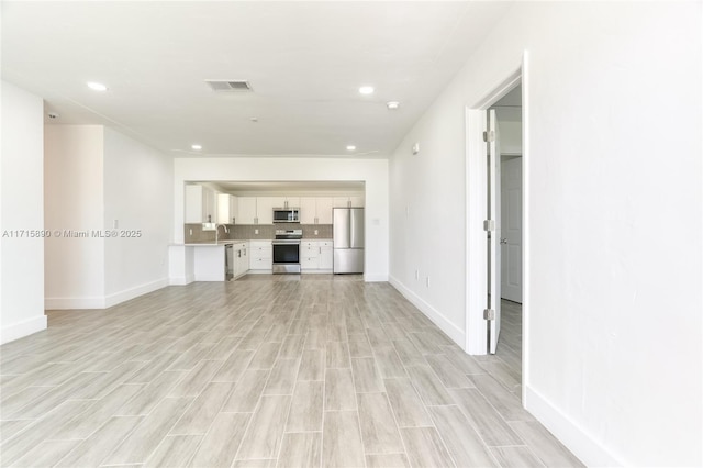 unfurnished living room with light hardwood / wood-style flooring